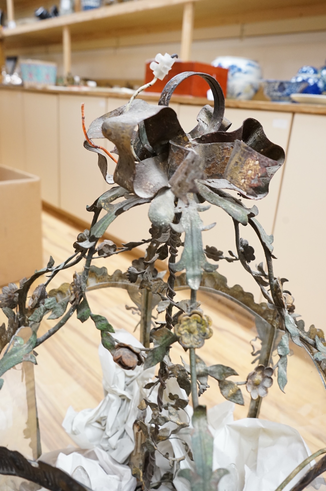A large French painted wrought iron decorative floral and swagged hexagonal hall lantern, 84cm high